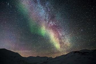 Aurora Borealis and Milky Way over Snowy Mountains
