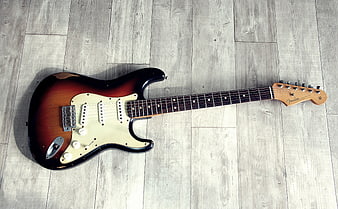 Sunburst Fender Electric Guitar On Gray Wood Floor