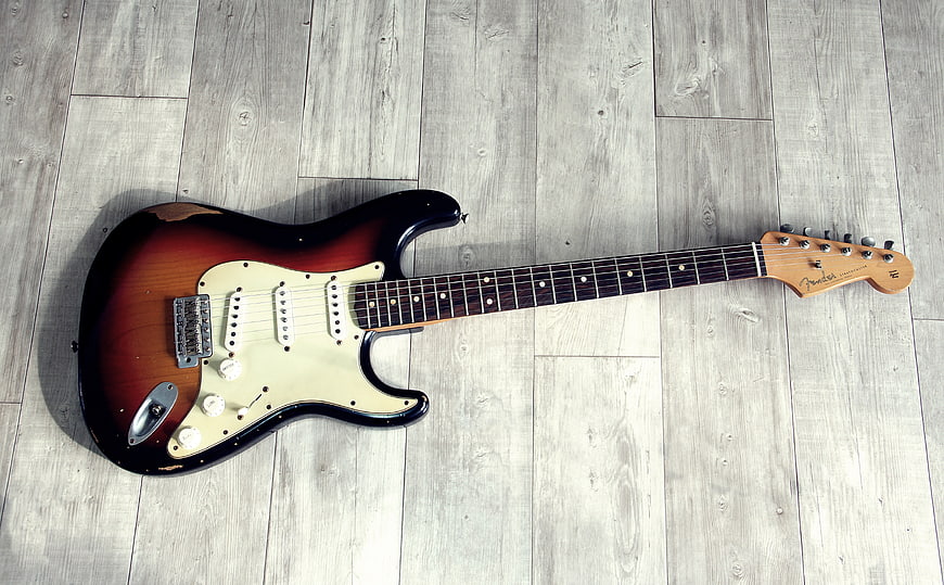 Sunburst Fender Electric Guitar On Gray Wood Floor