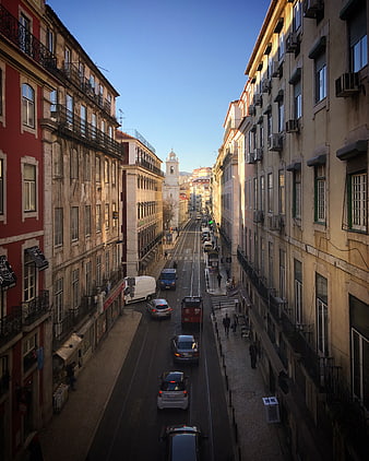 Sunlit European Street with Tram Tracks and Historic Buildings