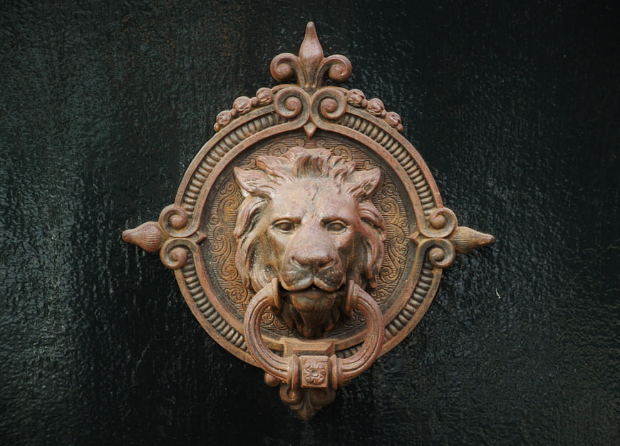 Vintage Bronze Lion Head Door Knocker On Dark Textured Door
