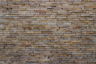 Textured beige stone brick wall background