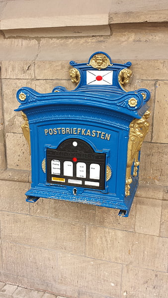Vintage Blue and Gold Post Box on Stone Wall