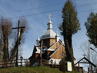 Traditional wooden church with silver domes and cross