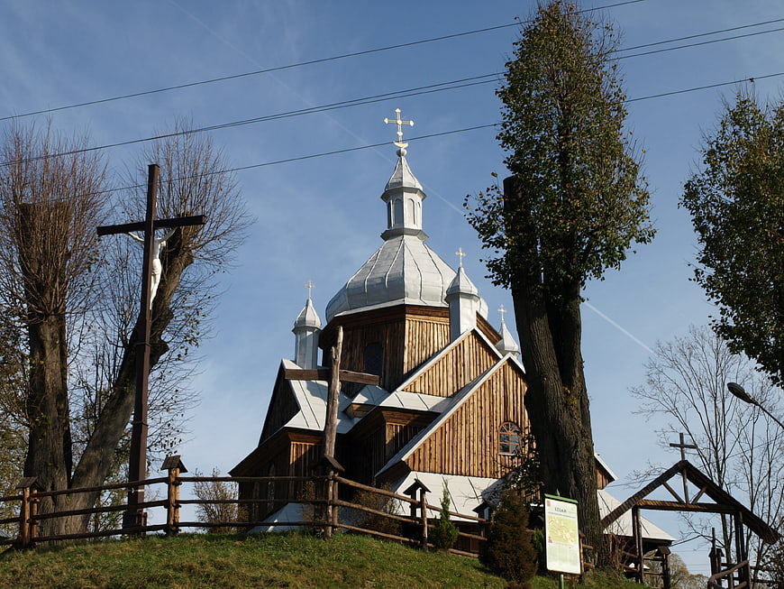 Traditional wooden church with silver domes and cross