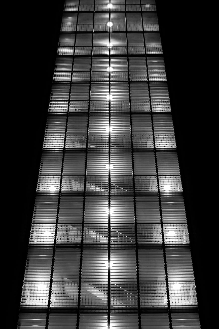 Black and white abstract office staircase through blinds