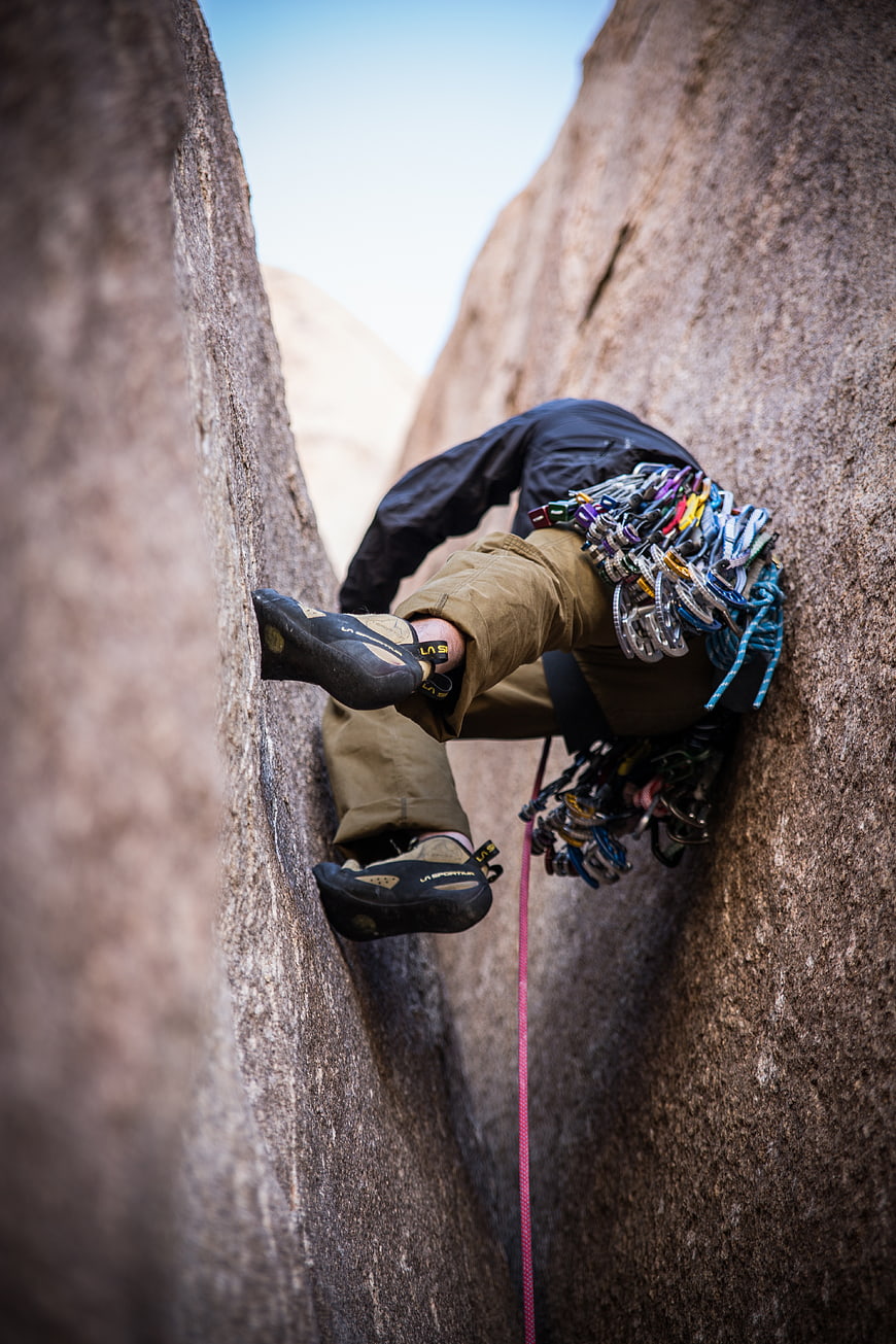 Rock Climber in Narrow Crack with Gear