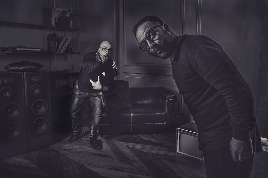 Two Men in Dramatic Black and White Studio Setting