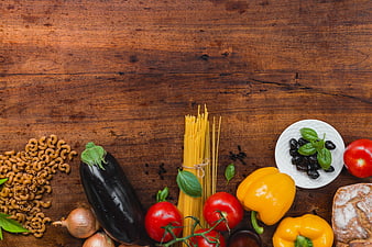 Italian pasta ingredients on rustic wooden table background