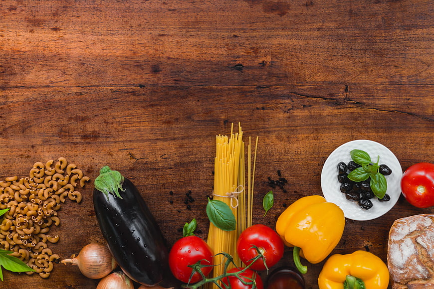 Italian pasta ingredients on rustic wooden table background