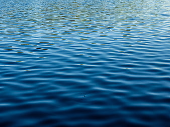 Blue Water Surface with Gentle Ripples and Reflections