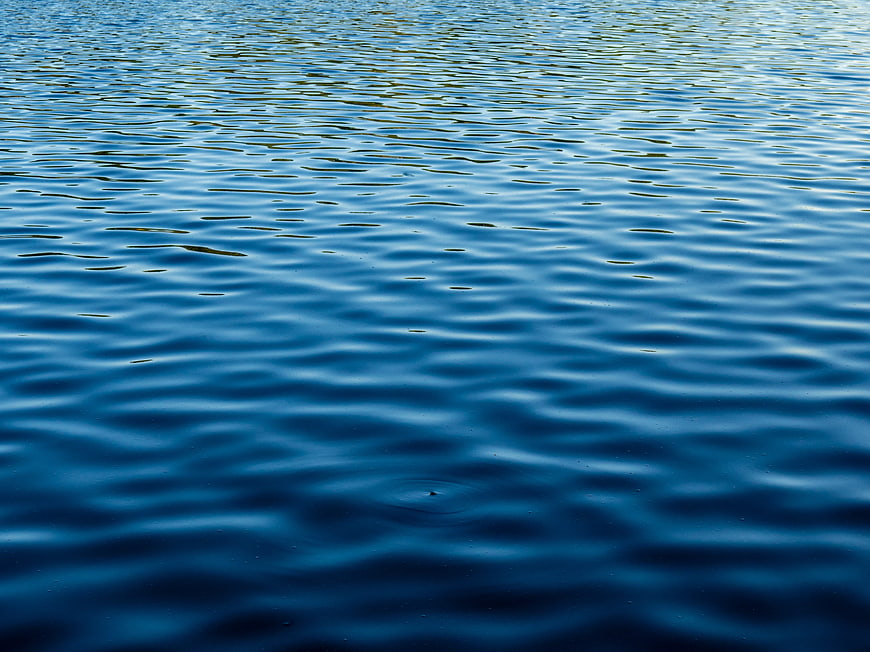 Blue Water Surface with Gentle Ripples and Reflections