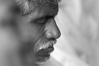 Close-up black and white portrait of elderly man with closed eyes