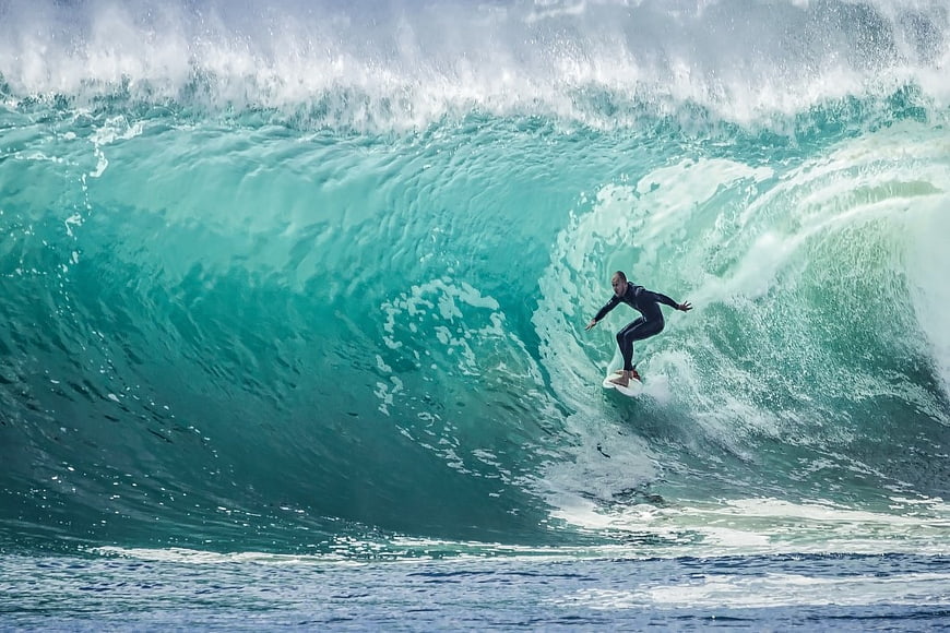 Surfer Riding Massive Turquoise Ocean Wave Barrel