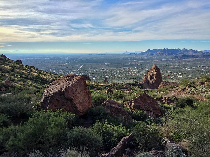 Scenic desert landscape with red rocks overlooking sprawling valley