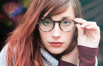 Close-up portrait of woman with red hair and glasses