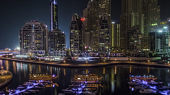 Dubai Marina Night Skyline with Illuminated Skyscrapers and Boats