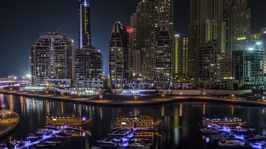 Dubai Marina Night Skyline with Illuminated Skyscrapers and Boats