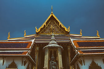 Golden Thai Temple Roof Architecture Against Blue Sky
