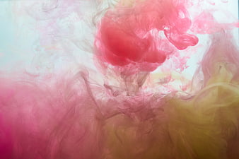 Abstract pink and yellow ink swirling in water background