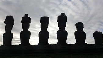 Silhouetted Moai Statues Against Dramatic Cloudy Sky