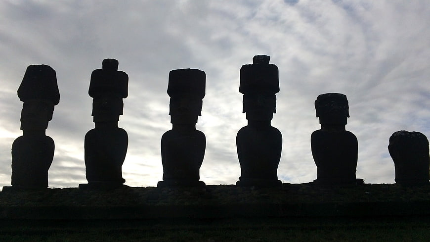 Silhouetted Moai Statues Against Dramatic Cloudy Sky