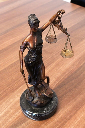 Bronze Lady Justice Statue on Wooden Table