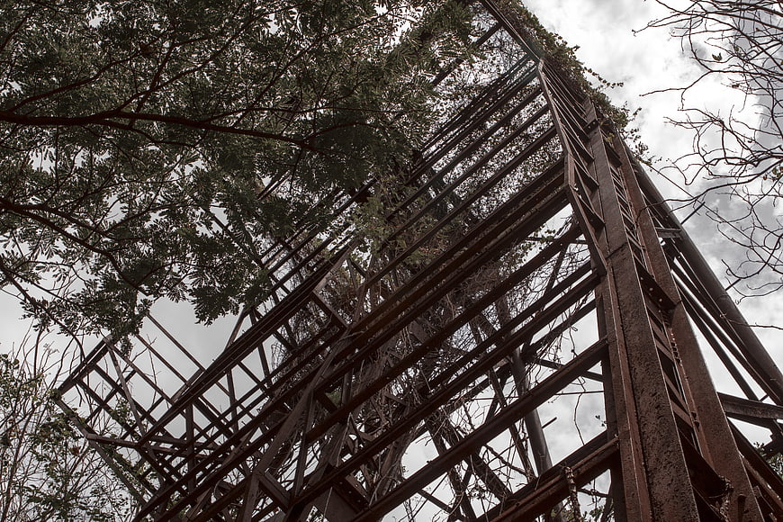 Low angle view of rusty abandoned metal tower structure
