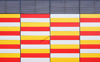 Colorful striped architectural facade with red, yellow, and white panels