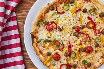 Top-Down View of Fresh Vegetable Pizza on White Plate
