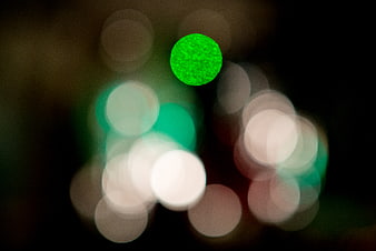 Abstract green bokeh lights on dark background
