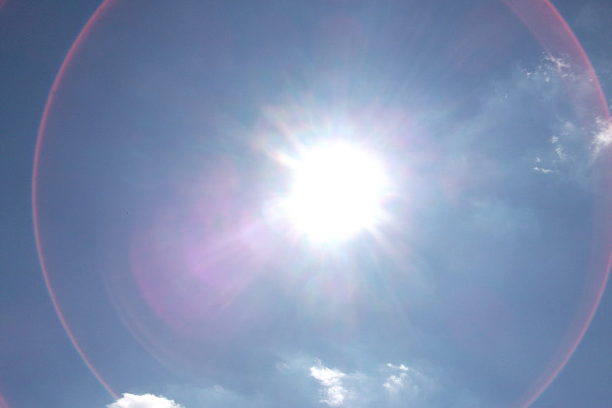 Bright Sun with Lens Flare in Blue Sky
