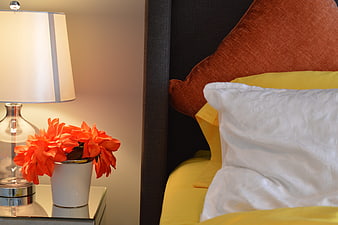Cozy Bedroom Interior With Bedside Lamp And Orange Flowers