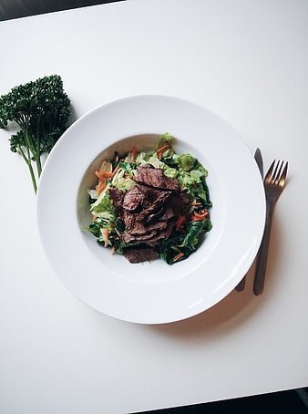 Top view of beef steak salad on white plate