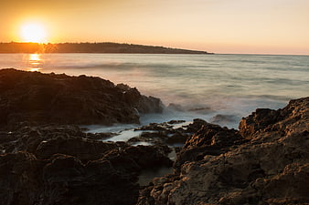 Long Exposure Rocky Coastline at Golden Sunset