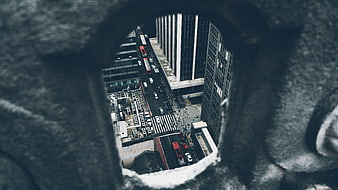 High angle view of city street through stone hole