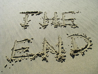 The words THE END written in sand on a beach