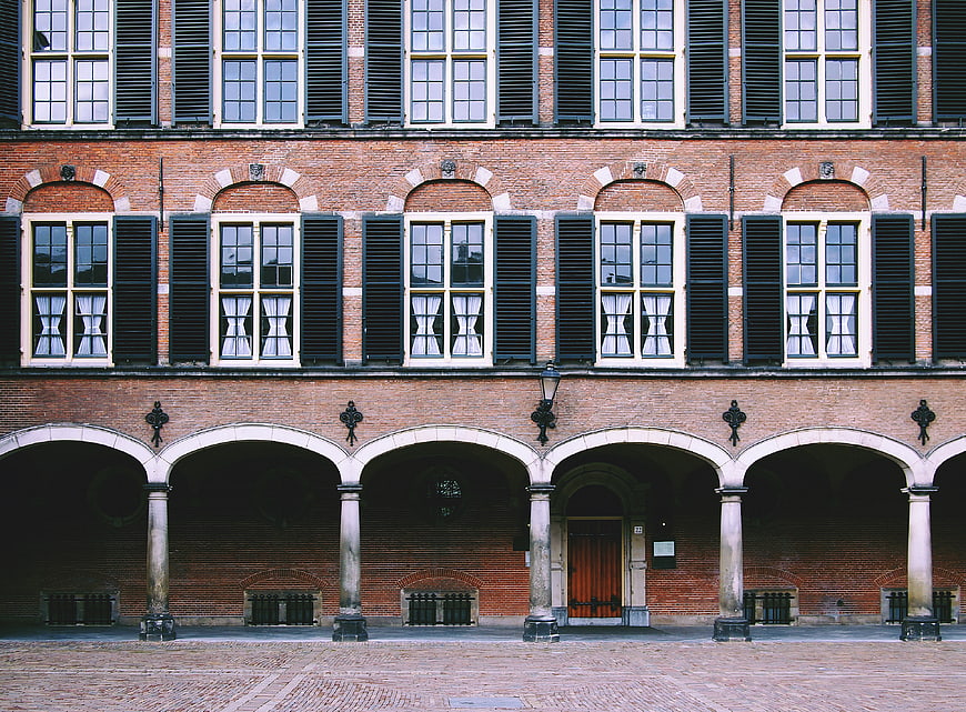 Symmetrical Brick Building with Arches and Shutters