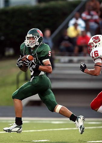 American Football Player Running with Ball in Green Uniform