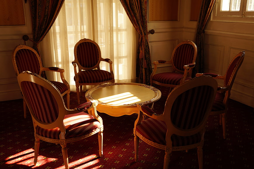 Sunlit vintage chairs and table in a classic room