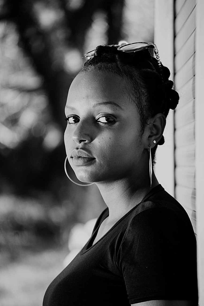 Black and white portrait of a confident woman with hoop earrings