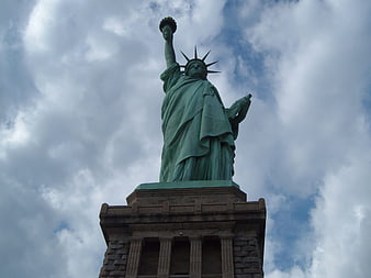 Low Angle View of Statue of Liberty Against Cloudy Sky