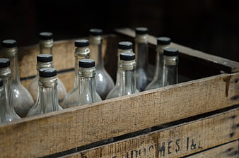 Vintage glass bottles in a rustic wooden crate