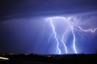 Dramatic Lightning Storm Over Dark Rural Landscape at Night
