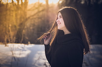 Smiling Woman with Long Hair in Winter Sunset