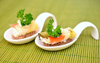 Gourmet canapés with salmon and cheese on white spoons