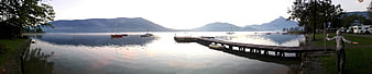 Panoramic Lake View with Wooden Pier and Mountains at Sunrise