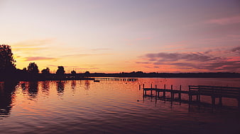 Serene Sunset Over Lake with Wooden Dock Silhouette