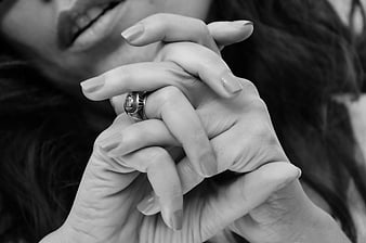Black and white close-up of woman's hands holding ring