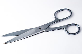 Silver metal scissors on white background